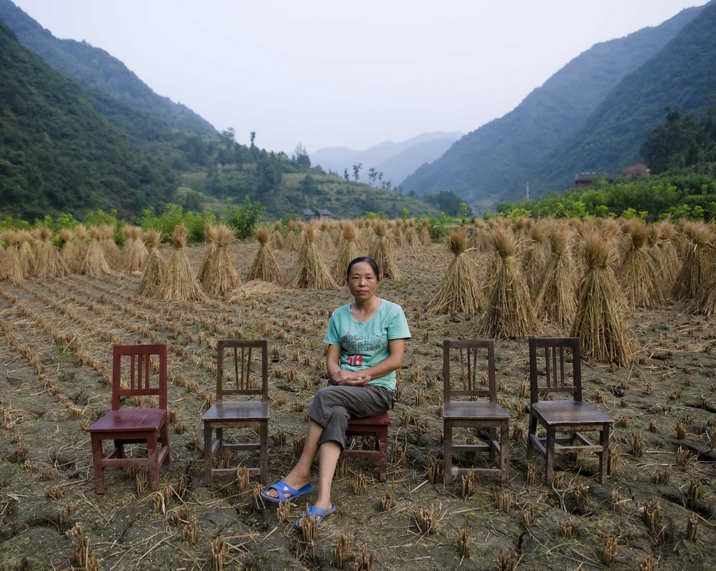 陕西省安康市石转镇，陈荣英在家门前的田地里，她的丈夫和两个孩子在外打工（8月29日摄）。